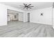 Open living room featuring light gray flooring, modern ceiling fan and white walls at 6124 Green View Dr # 139, Sarasota, FL 34231