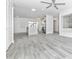 This spacious living room boasts new gray laminate flooring, white walls, recessed lighting, and an open kitchen layout at 6124 Green View Dr # 139, Sarasota, FL 34231