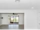 Bright living room features wood-look floors, ceiling fan, and sliding glass doors to the backyard at 6124 Green View Dr # 139, Sarasota, FL 34231