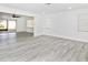 Open concept living room with wood-look floors, sliding glass doors, and lots of natural light at 6124 Green View Dr # 139, Sarasota, FL 34231