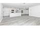 Open living space featuring a modern kitchen with white cabinets and stainless appliances adjacent to living area at 6124 Green View Dr # 139, Sarasota, FL 34231