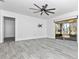 Expansive living space featuring modern ceiling fan, sliding glass door and light gray flooring at 6124 Green View Dr # 139, Sarasota, FL 34231
