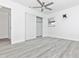 Large bedroom with a closet, ceiling fan, gray floors, and a TV mount at 6124 Green View Dr # 139, Sarasota, FL 34231