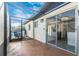 A covered patio opens to the home with large sliding glass doors leading to a modern updated kitchen at 6124 Green View Dr # 139, Sarasota, FL 34231