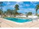 Community pool with well-maintained deck and clear blue water, surrounded by lush landscaping at 6124 Green View Dr # 139, Sarasota, FL 34231