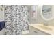 Charming bathroom features a blue and white shower curtain and round mirror at 6406 Auburn Ave, Bradenton, FL 34207