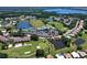Beautiful aerial view of the community with golf course, lake, swimming pool, tennis court, clubhouse, and homes at 6501 Stone River Rd # 205, Bradenton, FL 34203