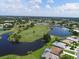 Aerial view showcasing a scenic golf course, serene lakes, and a vibrant community at 6501 Stone River Rd # 205, Bradenton, FL 34203
