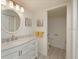Bathroom featuring a marble vanity with a round mirror and modern lighting at 6501 Stone River Rd # 205, Bradenton, FL 34203