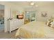 Inviting bedroom with a dresser, television, and sliding door to the outside at 6501 Stone River Rd # 205, Bradenton, FL 34203
