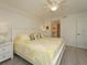 Bright bedroom featuring a ceiling fan, white walls, and a bathroom entrance at 6501 Stone River Rd # 205, Bradenton, FL 34203