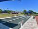 Well-maintained bocce ball court with blue canopies, benches, and landscaping in a lovely community at 6501 Stone River Rd # 205, Bradenton, FL 34203