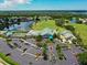 Well-maintained clubhouse with tennis court, pool, and lush landscaping in a beautiful community at 6501 Stone River Rd # 205, Bradenton, FL 34203