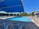 Inviting community pool with ample lounge chairs and shade structures in a resort-style setting at 6501 Stone River Rd # 205, Bradenton, FL 34203