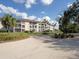 Spacious condominium complex surrounded by lush landscaping and swaying palm trees at 6501 Stone River Rd # 205, Bradenton, FL 34203