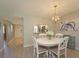 Cozy dining area with modern light fixture and easy access to the kitchen at 6501 Stone River Rd # 205, Bradenton, FL 34203