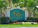 Elegant entrance sign for Tara Golf & Country Club with lush landscaping and colorful flowers at 6501 Stone River Rd # 205, Bradenton, FL 34203