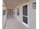 Exterior hallway featuring unit number 205 with railing and windows at 6501 Stone River Rd # 205, Bradenton, FL 34203
