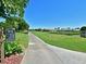Picturesque golf course view featuring a paved cart path winding through green fairways and water features at 6501 Stone River Rd # 205, Bradenton, FL 34203