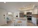 Modern kitchen features white cabinets, stainless steel appliances, and a convenient breakfast bar at 6501 Stone River Rd # 205, Bradenton, FL 34203