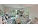 Bright living room boasts modern décor, sliding glass doors, and open access to the bedroom at 6501 Stone River Rd # 205, Bradenton, FL 34203