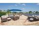 Outdoor lounge seating area with comfortable wicker furniture, shade canopies, and lake views at 6501 Stone River Rd # 205, Bradenton, FL 34203