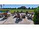 Relaxing outdoor patio space with Adirondack chairs, perfect for gatherings overlooking the green space at 6501 Stone River Rd # 205, Bradenton, FL 34203