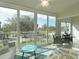Bright sunroom with large windows offering beautiful golf course views and natural light at 6501 Stone River Rd # 205, Bradenton, FL 34203