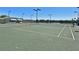 Well-maintained tennis courts for recreational play, surrounded by fencing and lighting at 6501 Stone River Rd # 205, Bradenton, FL 34203