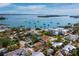 Beautiful aerial view of a waterfront home with boats on the water and nearby tropical landscaping at 691 Linley St, Longboat Key, FL 34228