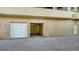 Exterior of a residential garage featuring a brick drive and tan walls at 1241 Gulf Of Mexico Dr # 1005, Longboat Key, FL 34228