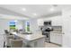 Bright open kitchen features stainless appliances, ample counter space, and seamless dining area access at 128 Sequoyah Dr, Port Charlotte, FL 33954