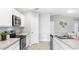 Well-equipped kitchen offering stainless steel appliances, sleek countertops, and modern white cabinetry at 128 Sequoyah Dr, Port Charlotte, FL 33954