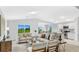 Spacious open-concept living area, naturally lit and featuring seamless transition into the gourmet kitchen at 128 Sequoyah Dr, Port Charlotte, FL 33954