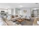Bright, open living room with modern furnishings, neutral tones, and easy access to the kitchen at 128 Sequoyah Dr, Port Charlotte, FL 33954