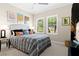Cozy bedroom with neutral walls, two windows with blinds, and a plush bed with decorative pillows at 13038 Prima Dr, Bradenton, FL 34211