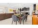 Open floor plan shows dining area with table and chairs next to kitchen with island at 13038 Prima Dr, Bradenton, FL 34211