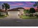 Charming home showcasing a tiled roof, stone accents, well-maintained landscaping, and inviting two-car garage at 13038 Prima Dr, Bradenton, FL 34211
