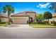 Charming home showcasing a tiled roof, stone accents, well-maintained landscaping, and inviting two-car garage at 13038 Prima Dr, Bradenton, FL 34211