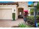 Close-up showcasing the home's stone entry and colorful plantings at 13038 Prima Dr, Bradenton, FL 34211
