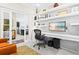 Bright home office with custom shelving, recessed lights, and a sleek modern desk and chair at 13038 Prima Dr, Bradenton, FL 34211