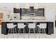 Modern kitchen features stainless appliances, a large island with seating, and sleek dark cabinets at 13038 Prima Dr, Bradenton, FL 34211
