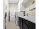 Convenient laundry room with a washer and dryer, cabinetry, countertop, and a sink at 13038 Prima Dr, Bradenton, FL 34211