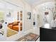 Office featuring glass doors, two orange chairs, and decorative rug at 13038 Prima Dr, Bradenton, FL 34211