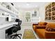 Office featuring a large desk, floating shelves, and two armchairs at 13038 Prima Dr, Bradenton, FL 34211