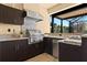 Outdoor kitchen with stainless steel appliances, sink, and granite counters at 13038 Prima Dr, Bradenton, FL 34211