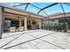 Spacious screened lanai with a bar and seating area, flowing to the indoor kitchen, ideal for entertaining at 13038 Prima Dr, Bradenton, FL 34211
