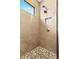 Close-up of shower featuring decorative tile with a mosaic floor and dual shower heads at 13038 Prima Dr, Bradenton, FL 34211