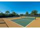 Well-maintained tennis and pickleball courts surrounded by lush landscaping and clear blue skies at 13038 Prima Dr, Bradenton, FL 34211
