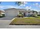 Charming single-story home features a two-car garage and a well-maintained front lawn, enhancing its curb appeal at 14205 Nighthawk Ter, Lakewood Ranch, FL 34202